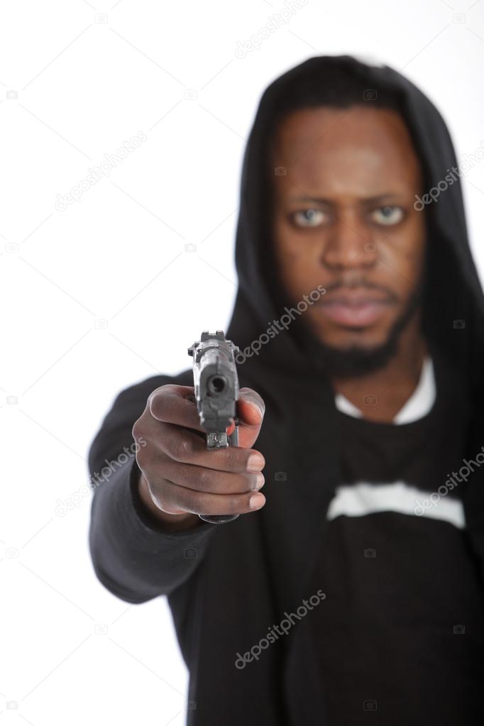 African thug aiming a gun at the camera