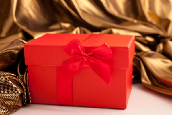 Red gift box with luxury gold fabric — Stock Photo, Image