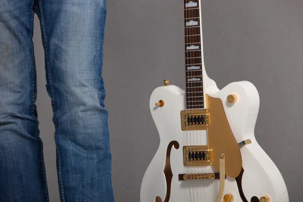 Hombre sosteniendo una guitarra eléctrica blanca —  Fotos de Stock