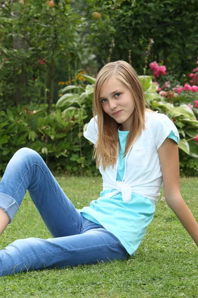 Thin young teenage girl relaxing on the lawn — Stock Photo, Image