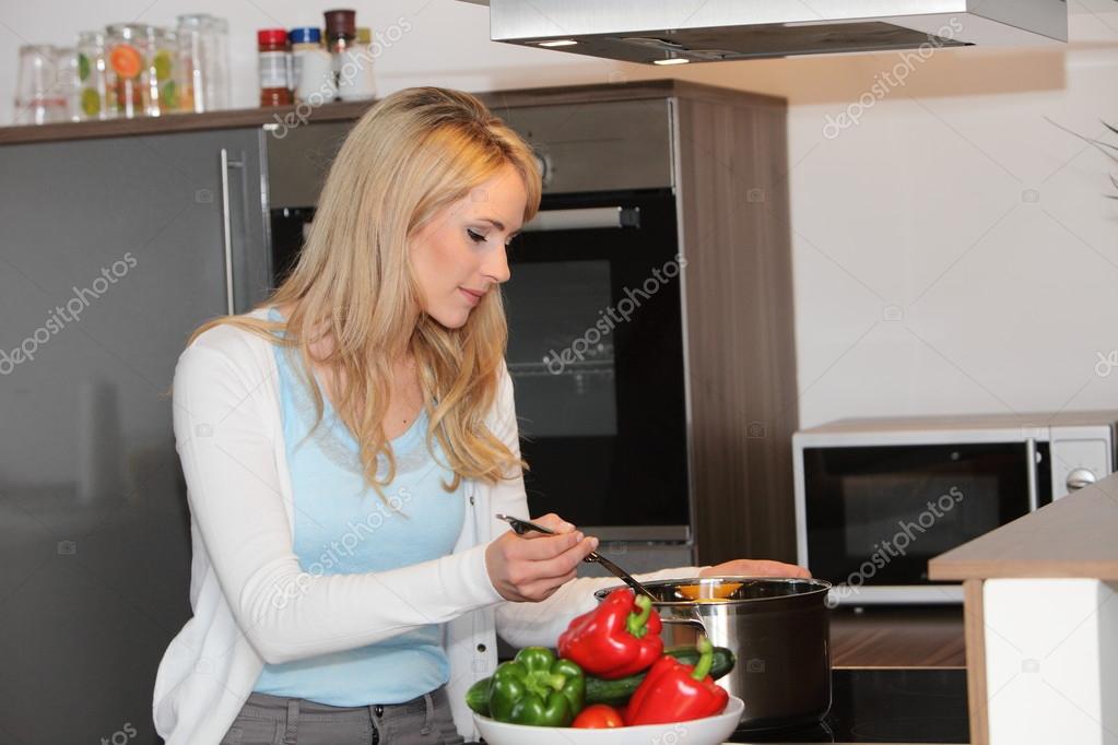 Funny young housewife cooking in kitchen Stock Photo - Alamy