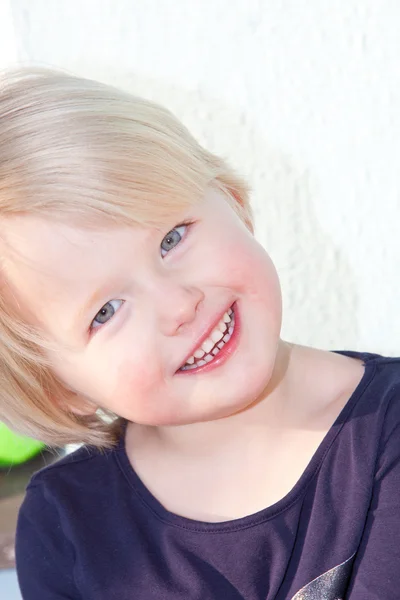 Smiling beautiful little blond girl — Stock Photo, Image