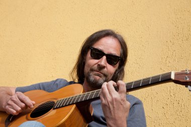 Sakallı orta yaşlı adam gitar çalmak