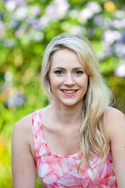 Blond long-haired woman with a ravishing smile — Stock Photo, Image