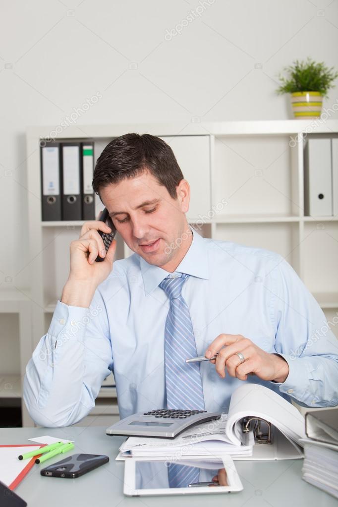 Confident accountant talking on mobile phone