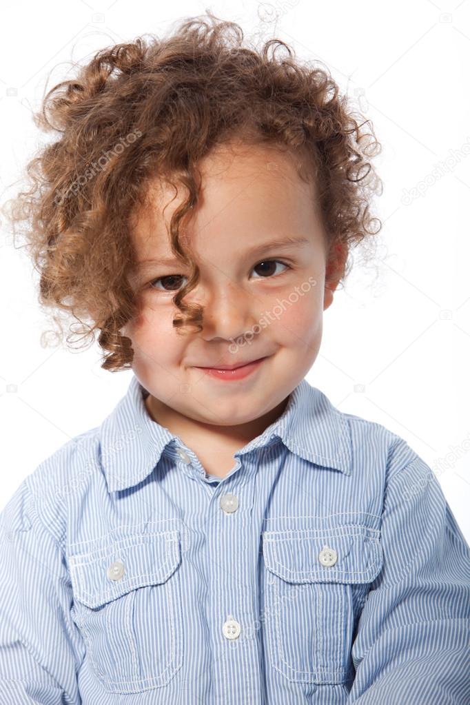 Young boy with curly hair smiling Stock Photo by ©Farina6000 50041775