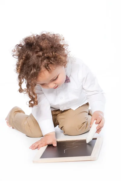 Curly Kid Practice Writing on Black Board — Stock Photo, Image