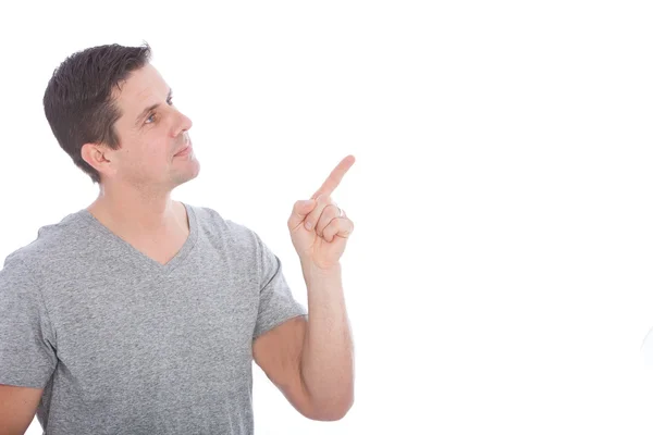 Hombre joven con camisa gris señalando hacia arriba — Foto de Stock