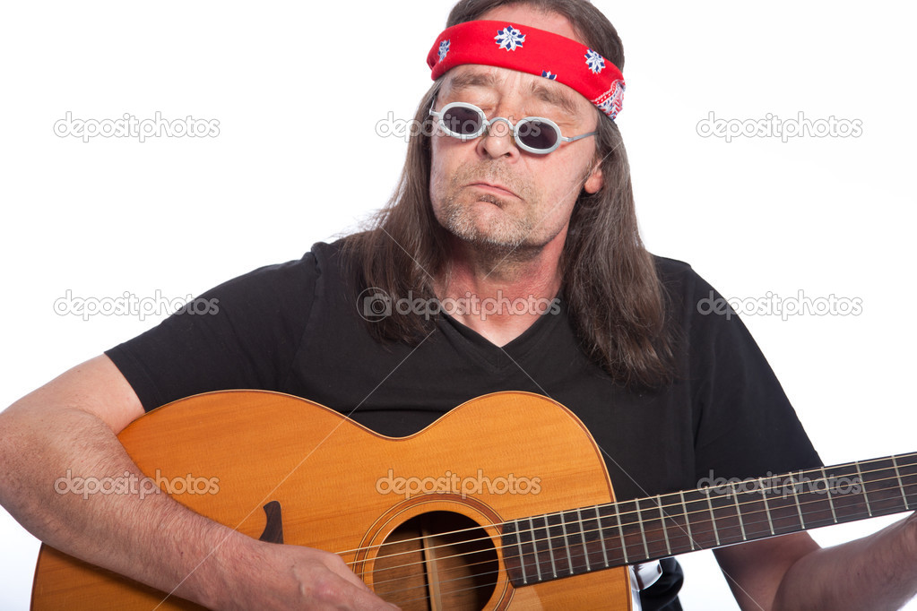 Middle-aged bohemian male artist playing guitar