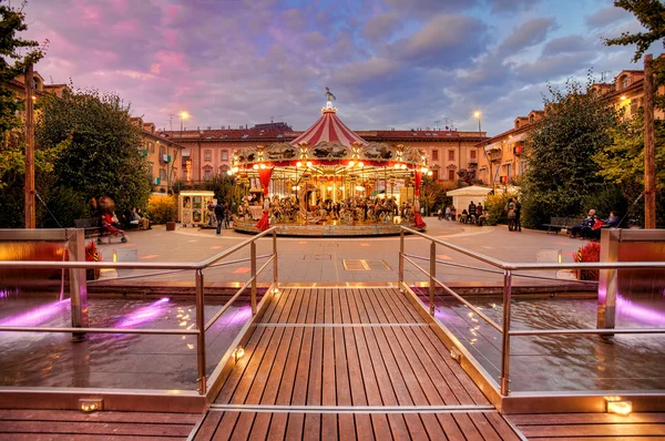 Carousel at evening in city center. Alba, Italy — Stock Photo, Image