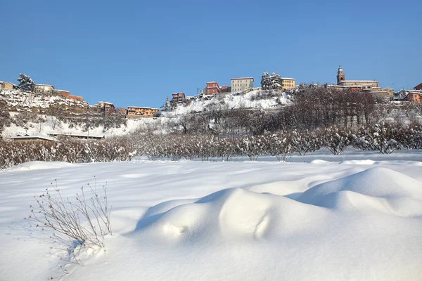 Small town on the hill covered by snow. Piedmont, Italy. — Stock Photo, Image