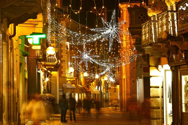 Central street at evening. Alba, Italy.