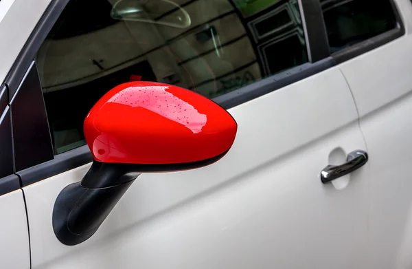 Red side mirror on white car. — Stock Photo, Image