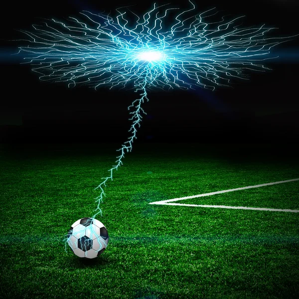 Soccer ball on the green field and lightning