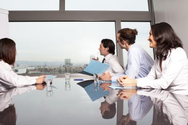 Four businesspeople looking out of the window clipart