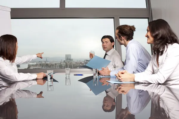 Four businesspeople looking out of the window Royalty Free Stock Photos