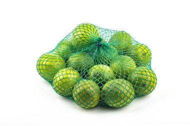 Fresh limes in the net green lime citrus fruit stand isolated on white background. Lime wedge with clipping path