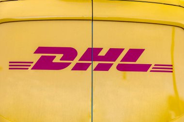 WETZLAR, GERMANY - 2021-10-01: DHL Logo on a yellow DHL Truck.  DHL is owned by the German postal service Deutsche Post.