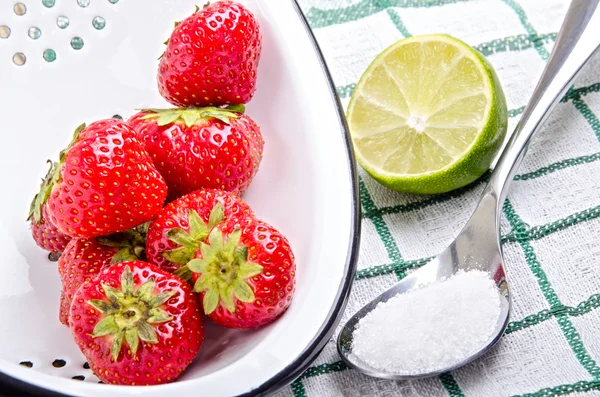 Strawberries with lime and sugar on a spoon — Stock Photo, Image
