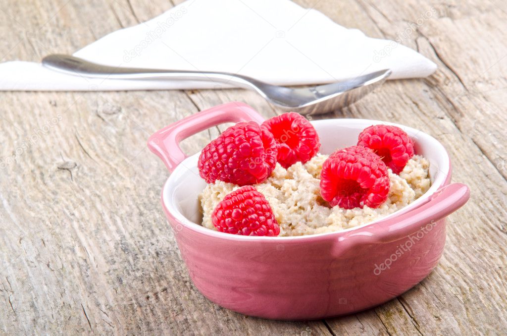 Porridge in a bowl with raspberry