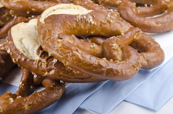 Salted pretzels on blue and white napkin — Stock Photo, Image