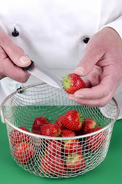 Female chef preparing some strawberries — Stock Photo, Image