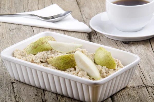 Porridge with sliced pear in a bowl — Stock Photo, Image