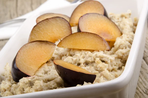 Freshly made porridge with plum — Stock Photo, Image