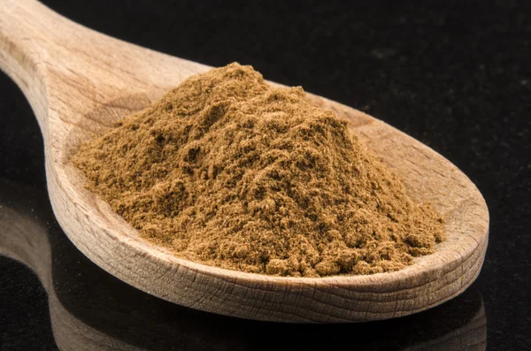 Ground cinnamon on a wooden spoon — Stock Photo, Image