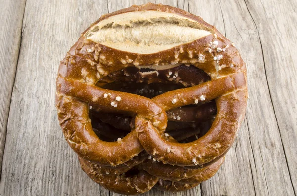 Salty pretzel on a wooden board — Stock Photo, Image