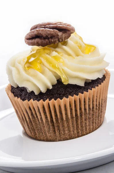 Chocolate cupcake with nut and syrup — Stock Photo, Image