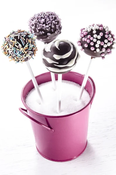 Pop cake with sprinkles in a pink bucket — Stock Photo, Image