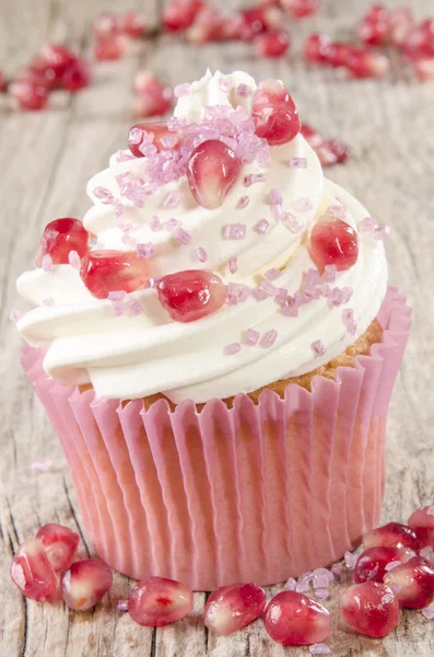 Cupcake with pomegranate and pink sprinkle — Stock Photo, Image