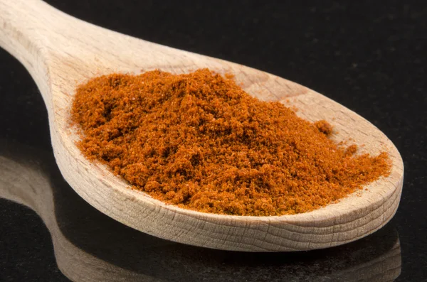 Paprika powder on a wooden spoon — Stock Photo, Image