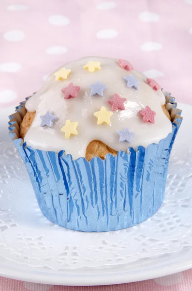 Cupcake with icing and colorful stars — Stock Photo, Image