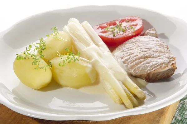 Asparagus with potato and pork chop — Stock Photo, Image