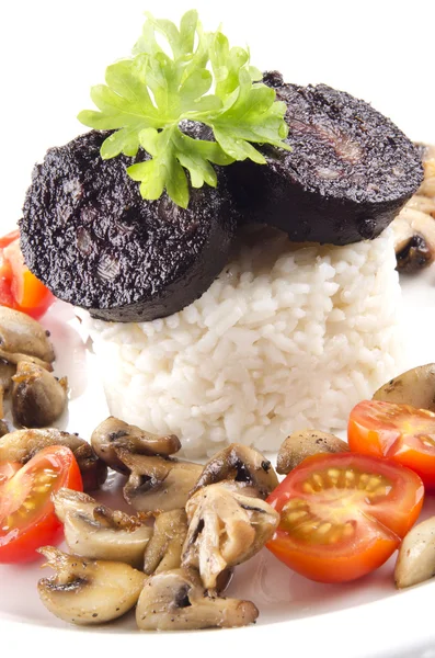 Rice with black pudding on a plate — Stock Photo, Image