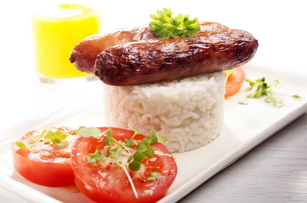 Grilled sausage on rice — Stock Photo, Image