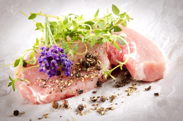 Raw pork chops with herbs — Stock Photo, Image