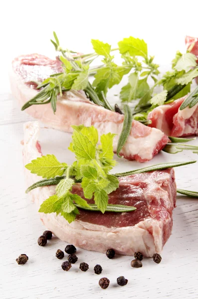 Lamb chops and some herbs — Stock Photo, Image