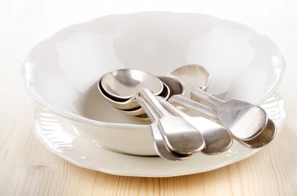 Empty porcelain bowl and spoon — Stock Photo, Image