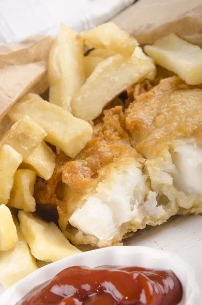 Fish and chips in a brown bag — Stock Photo, Image