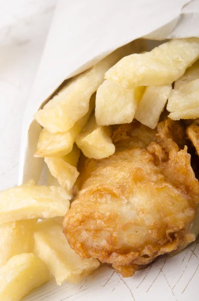 French fries and fish in a white bag — Stock Photo, Image