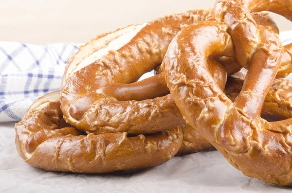 Home made bavarian prezel on baking paper — Stock Photo, Image