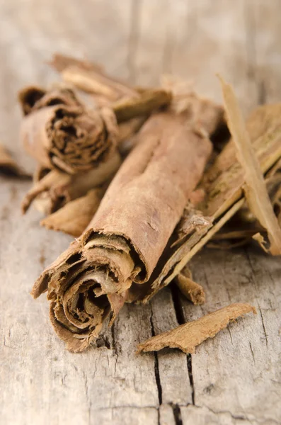 Cinnamon on an old wooden table — Stock Photo, Image