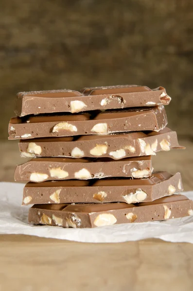 Broken milk chocolate with hazelnuts — Stock Photo, Image