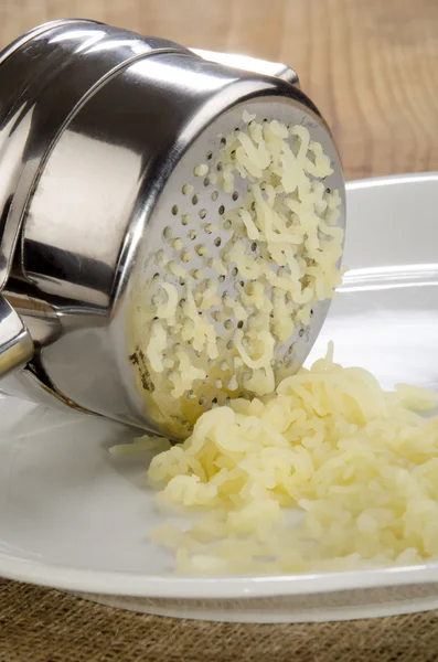 Potatoes are prepared in a potato press — Stock Photo, Image