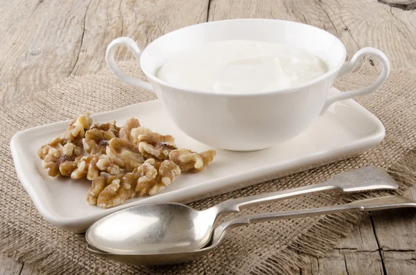 Greek yogurt with walnut on a plate — Stock Photo, Image