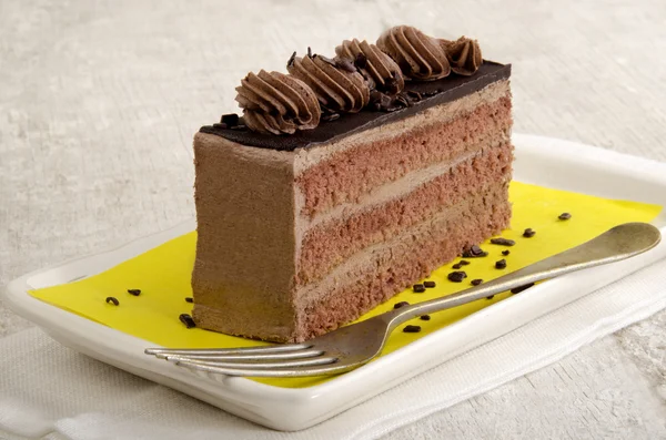 Piece of chocolate cake with sprinkles — Stock Photo, Image