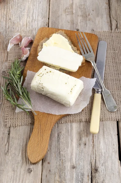 Home made cheese and bread on a wooden board — Stock Photo, Image